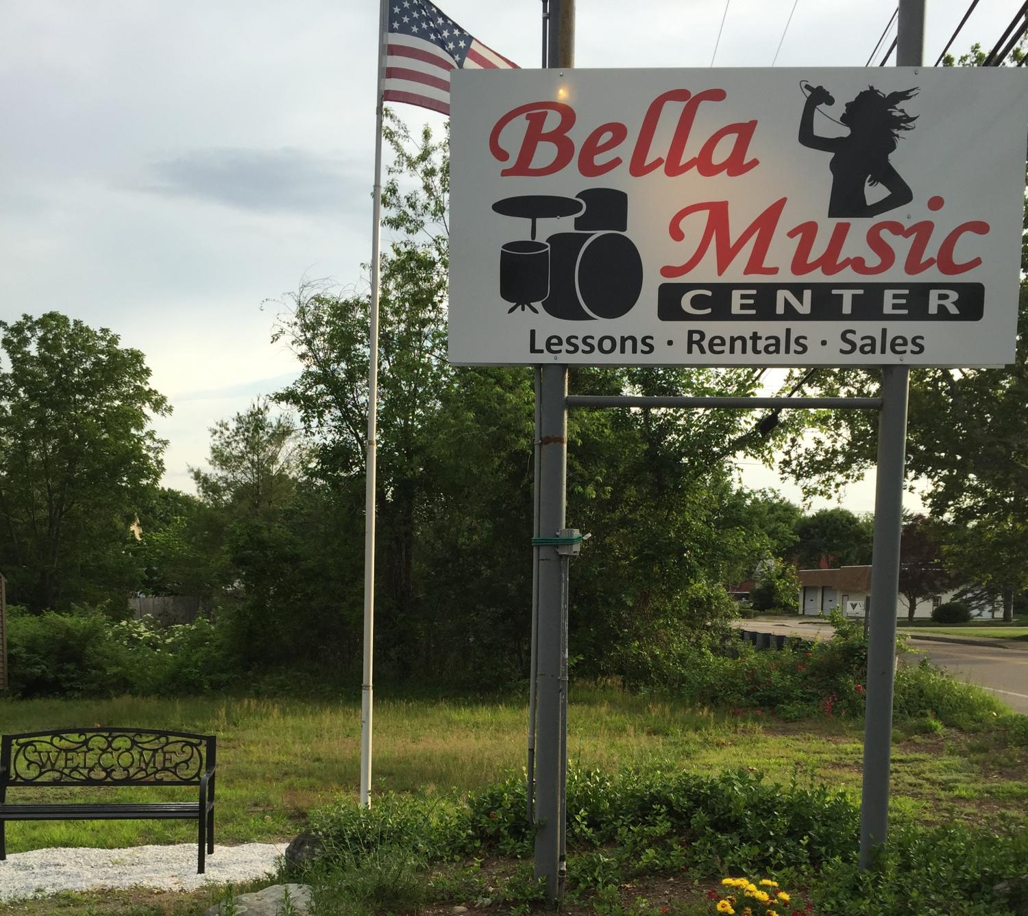 Bella Music Center roadside sign and welcome bench in Norton, Massachusetts